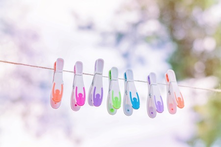 Plastic colorful clothespins on a rope, outsideの写真素材