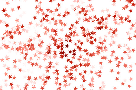 Stars confetti toned Living Coral color isolated on white background. Color of the 2019 year.