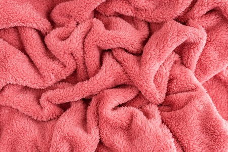 Close up top view of coral blanket wrinkled texture. Fluffy coral background. Color of the 2019 year.の写真素材