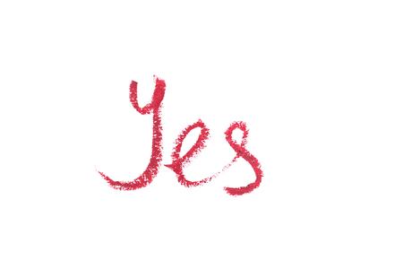 Word yes written with lipstick and isolated on white.の写真素材