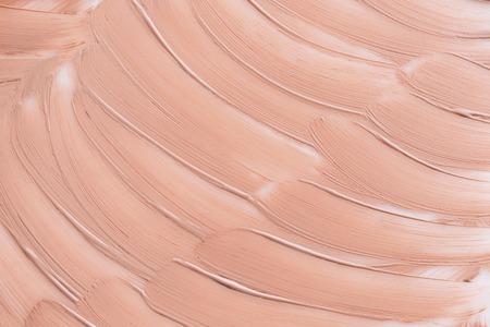 Beige smear of foundation texture. Cosmetics concept isolated on white background. Top view.の写真素材