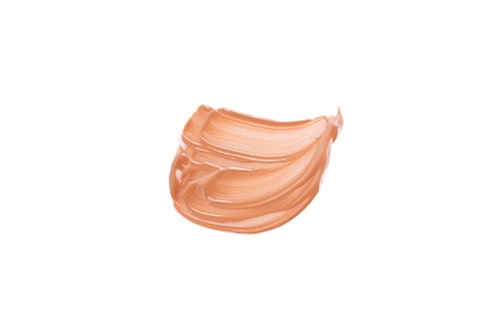Beige smear of foundation. Cosmetics concept isolated on white background. Top view.の写真素材