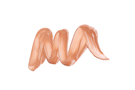 Beige smear of foundation. Cosmetics concept isolated on white background. Top view.の写真素材