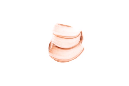 Beige smear of foundation. Cosmetics concept isolated on white background. Top view.の写真素材