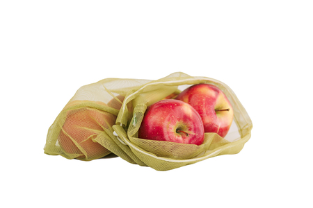 Reusable bag with red apples isolated on white background. Zero waste and plastic free shopping concept.の写真素材