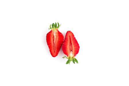Red strawberries cutted close up on white background. Isolated on white. Top view.の写真素材