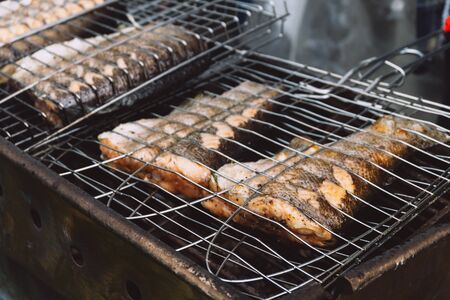 Red fish on hot grill. Barbeque in the garden in summer. Close up.の写真素材