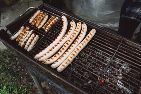 Barbequing sausages on hot grill. Top view. Close up.の写真素材