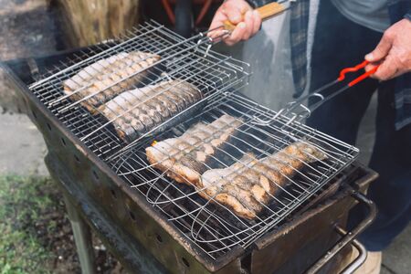 Red fish on hot grill. Barbeque in the garden in summer. Close up.の写真素材
