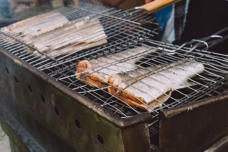 Red fish on hot grill. Barbeque in the garden in summer. Close up.の写真素材