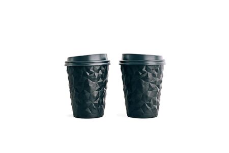 Two black coffee cups to go isolated on white. Unusual shape of cup, mock up. Copy space.の写真素材