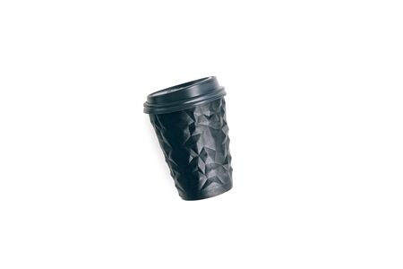 Black coffee cup to go isolated on white. Unusual shape of cup, mock up. Copy space.の写真素材