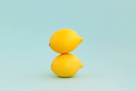 Tower of two lemons on pale blue backgrounds.の写真素材