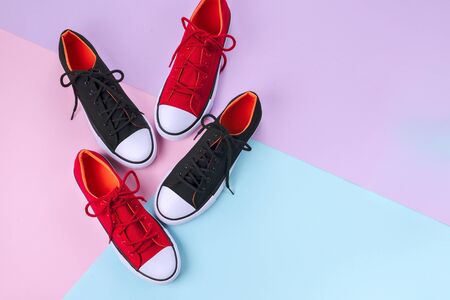New red and black sneakers on colorful background with copy space. Top view.の写真素材