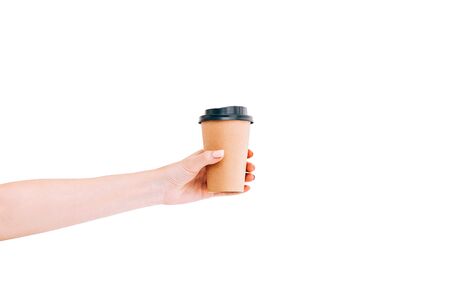 Paper coffee cup to go in woman's hand isolated on white. Mockup. Copy space.の写真素材