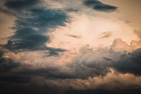 Stunning sky and sun behind dark grey clouds background. Sky view.の写真素材