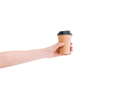 Paper coffee cup to go in womans hand isolated on white. Mockup.の写真素材