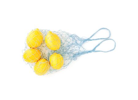 Reusable bag with lemons isolated on white background. Zero waste and plastic free shopping concept.の写真素材