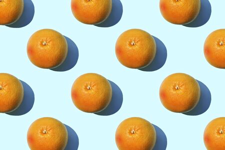 Ripe grapefruit pattern on blue background. Minimal flat lay concept.の写真素材