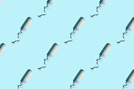 Hygiene female tampon pattern on blue background. Top view.の写真素材