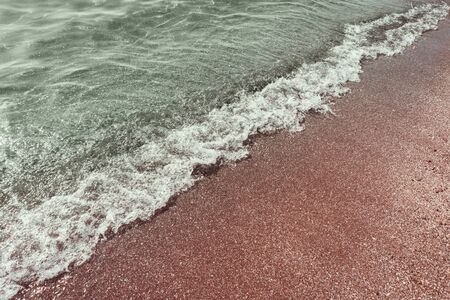 Soft mint tranquil green waves of the sea with white foam on the sandy beach. Copy space.の写真素材