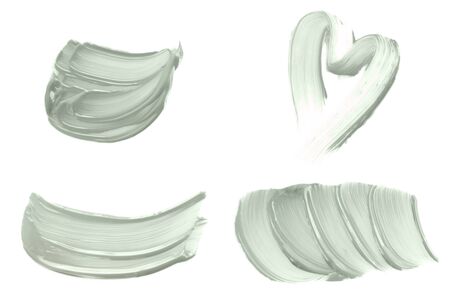 Set of abstract brush strokes toned tranquil mint green color isolated on white. Top view.の写真素材
