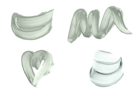 Set of abstract brush strokes toned tranquil mint green color isolated on white. Top view.の写真素材