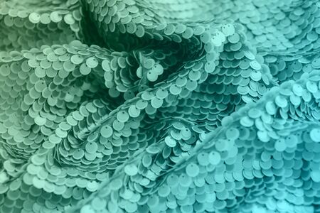 Mint green shiny fabric with sequins, abstract background. Toned actual colors for this season.の写真素材