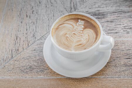 White big cup of delicious coffee with art on wooden table with copy space. Top view.の写真素材