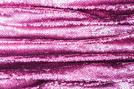 Pink purple shiny fabric with sequins, abstract background. Close-up.の写真素材