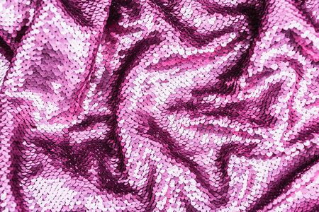 Pink purple shiny fabric with sequins, abstract background. Close-up.の写真素材