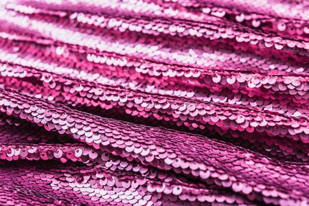 Pink purple shiny fabric with sequins, abstract background. Close-up.の写真素材