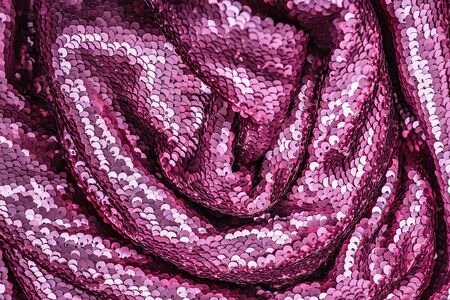 Pink purple shiny fabric with sequins, abstract background. Close-up, top view.の写真素材