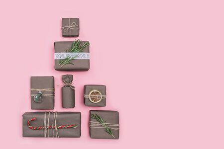 Christmas tree made of presents and gifts wrapped in craft paper. Flat lay with copy space. Holiday zero waste concept.の写真素材