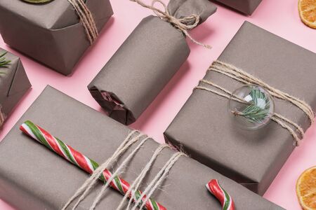 Presents and gifts wrapped in craft paper with decoration. Flat lay, close up. Holiday zero waste concept.の写真素材