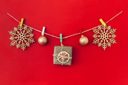 Christmas handmade garland made of golden snowflakes and other christmas decorations on red background. Christmas, New Year concept.の写真素材