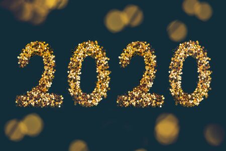 Golden stars sparkles shaped 2020 on dark background. Flatlay style, New Year concept.の写真素材