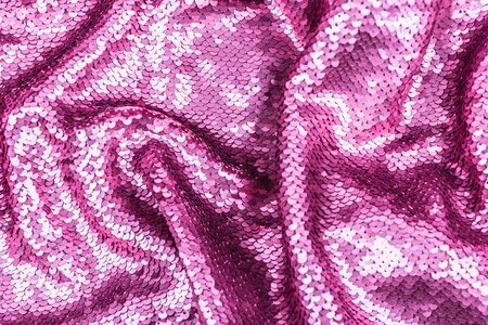 Pink purple shiny fabric with sequins, abstract background. Close-up.の写真素材