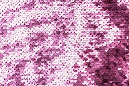 Pink purple shiny fabric with sequins, abstract background. Close-up.の写真素材