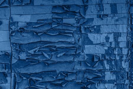 Texture of crackedpainted wall background toned blue color. Old cracked background, 2020.の写真素材