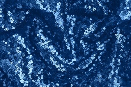 Festive shiny fabric with sequins, toned blue color. Abstract background, 2020.の写真素材