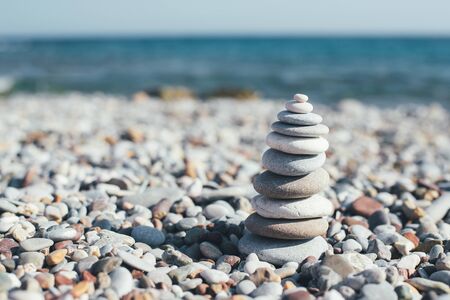 Stone pebble tower balancing on the beach. Copy space.の写真素材