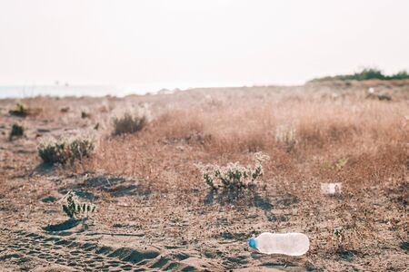Plastic bottles waste on a beach. Earth pollution concept. Copy space.の写真素材