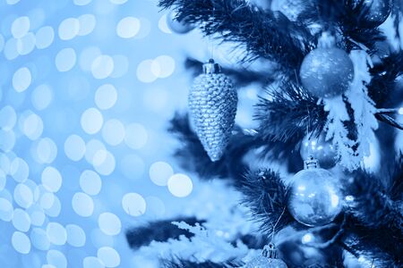 Christmas tree with toys in blue color. Decorated christmas tree toned blue color, 2020.の写真素材