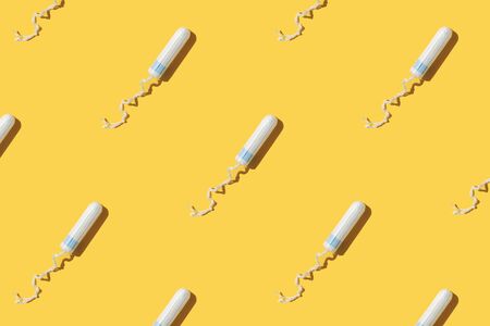 Hygiene female tampon pattern on yellow background. Top view.の写真素材