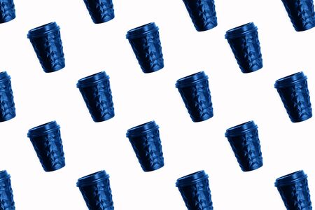 Pattern made with paper coffee cup to go toned blue color. Unusual shape of cup, mock up, isolated on white.の写真素材