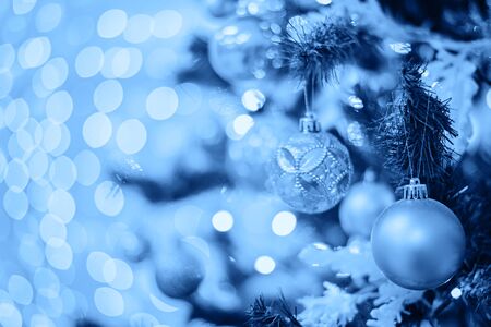 Christmas tree with toys in blue color. Decorated christmas tree toned blue color, 2020.の写真素材