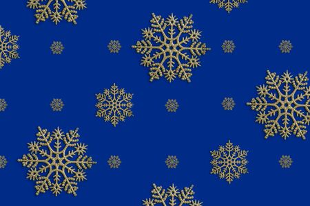 Golden snowflake christmas decoration on the blue background. New year greeting card. Holiday mock up.の写真素材