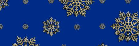 Golden snowflake christmas decoration on the blue background. New year greeting card. Holiday mock up.の写真素材