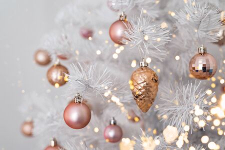 Decorated christmas tree with pink and golden toys on white background. Christmas concept, 2020. Copy space.の写真素材